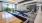 a large modern looking room with a pool table and chairs