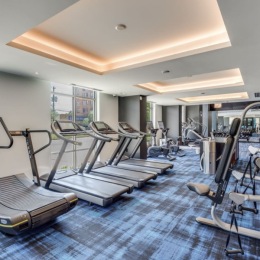 fitness center with open spaces and bright lighting through the windows
