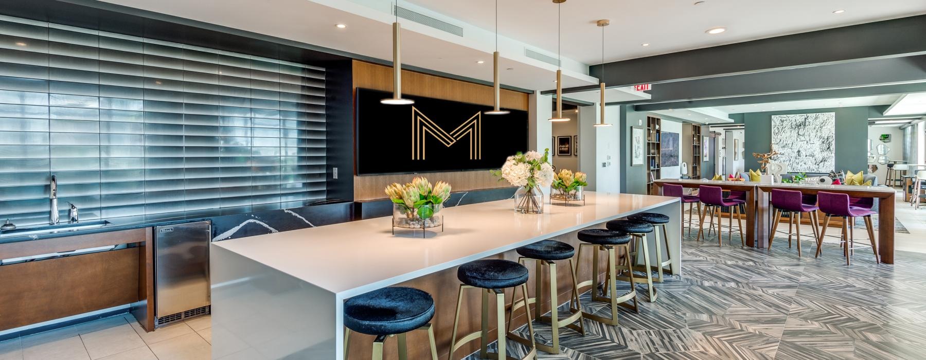a large room with a bar and stools